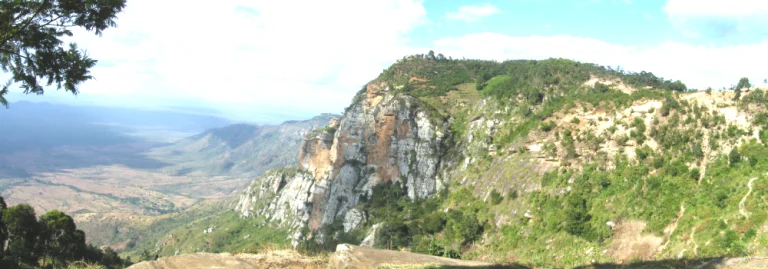 Panoramic view of rugged cliffs, green hills, and vast valleys visible during a Hola Africa excursion.
